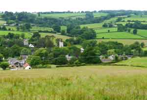 a dale in the woods marked by a church